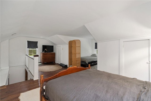 bedroom with vaulted ceiling and hardwood / wood-style flooring