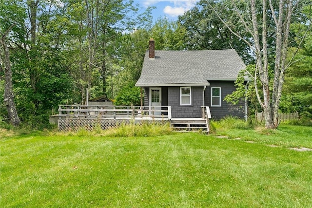 back of house with a lawn and a wooden deck