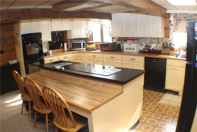 kitchen with white cabinets and black appliances