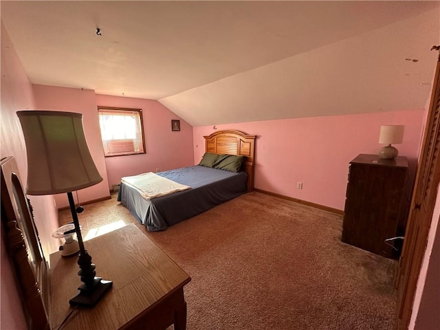 bedroom with lofted ceiling and carpet floors