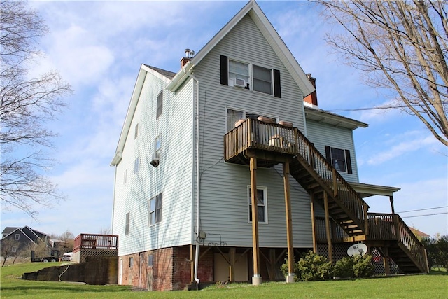 rear view of house featuring a yard