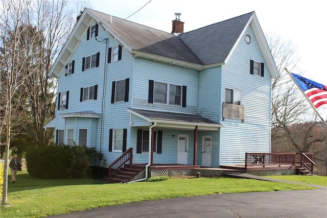 view of front of home featuring covered porch and a front yard