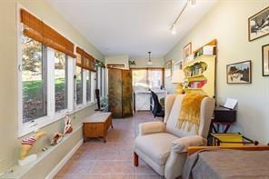 interior space with light tile patterned floors and track lighting