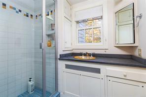 bathroom featuring vanity and an enclosed shower