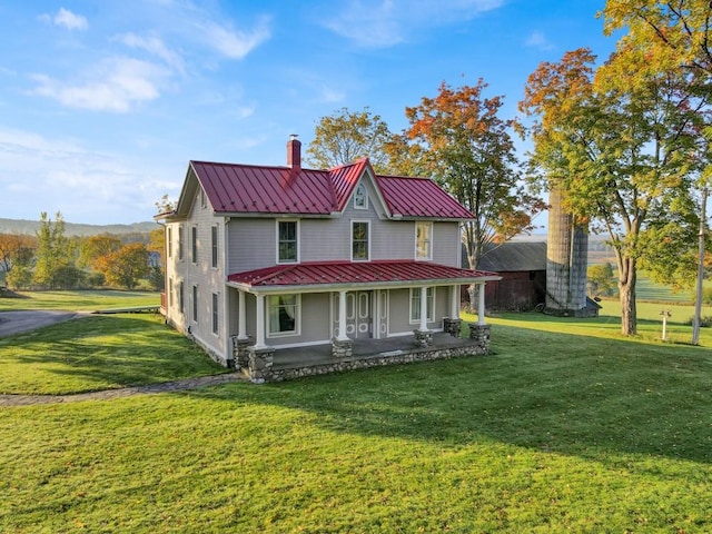 view of front of home with a porch and a front yard