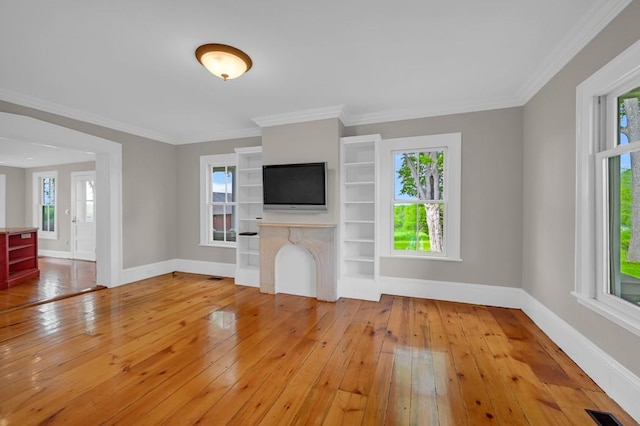 unfurnished living room with light hardwood / wood-style flooring and ornamental molding