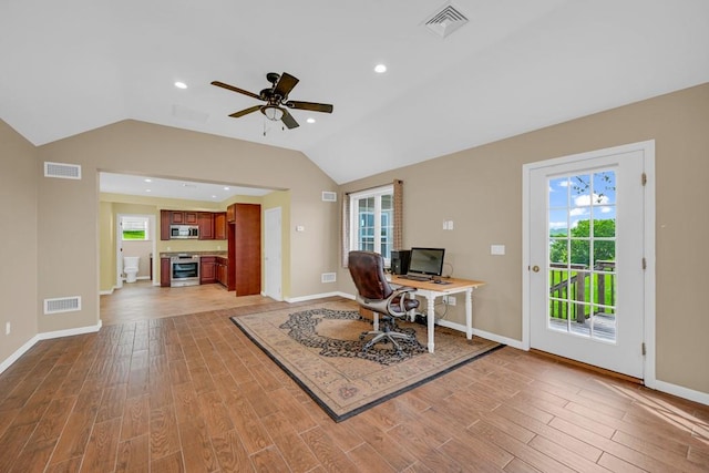 office space featuring light wood-type flooring, vaulted ceiling, and ceiling fan