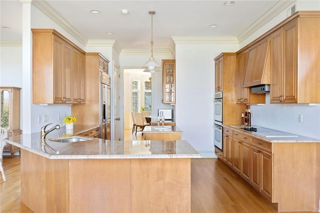 kitchen with kitchen peninsula, ornamental molding, white appliances, sink, and light hardwood / wood-style floors