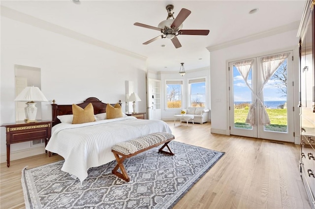 bedroom with ceiling fan, french doors, light hardwood / wood-style flooring, access to outside, and ornamental molding