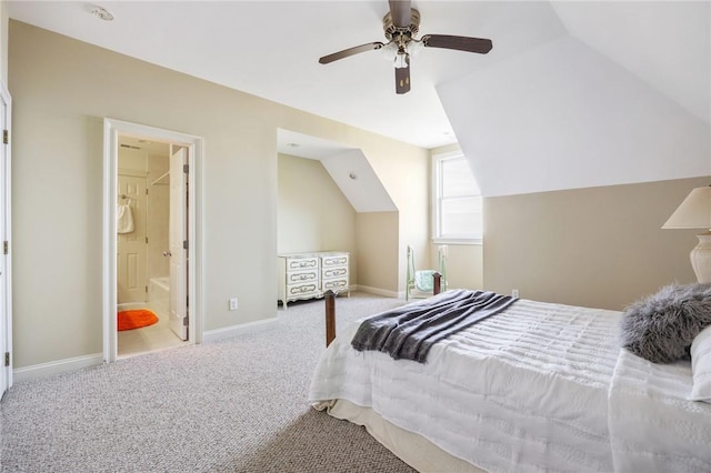 bedroom with connected bathroom, ceiling fan, light carpet, and vaulted ceiling