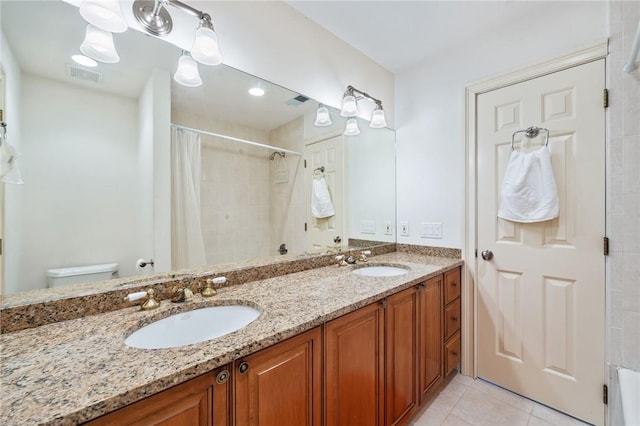 bathroom with tile patterned floors, vanity, toilet, and walk in shower