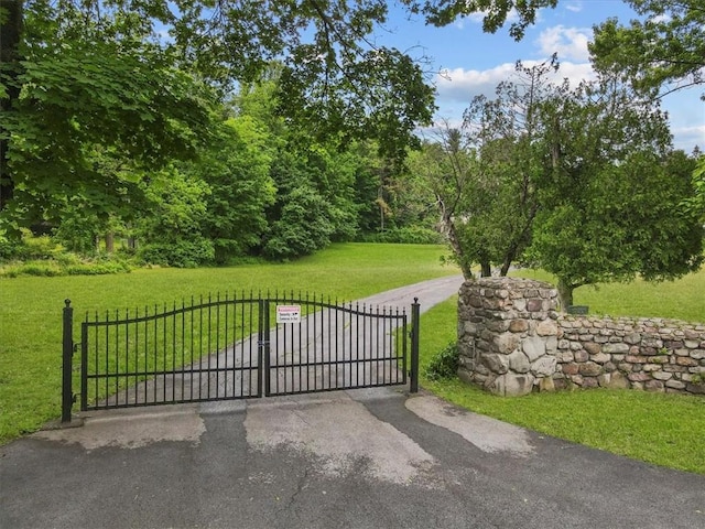 view of gate featuring a yard