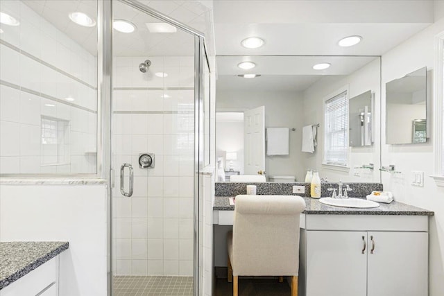 bathroom featuring a stall shower and vanity