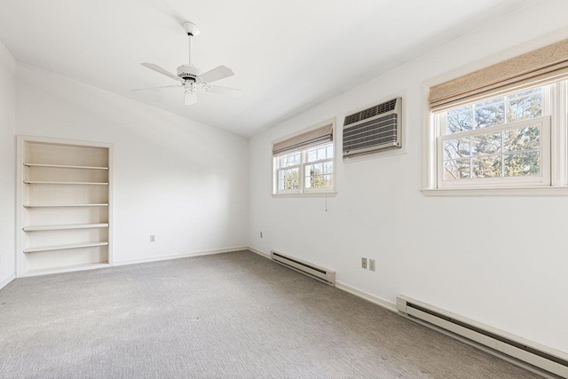 unfurnished room featuring a baseboard radiator, baseboards, carpet flooring, and a wall mounted air conditioner