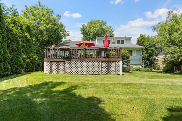 back of property featuring a yard and a wooden deck