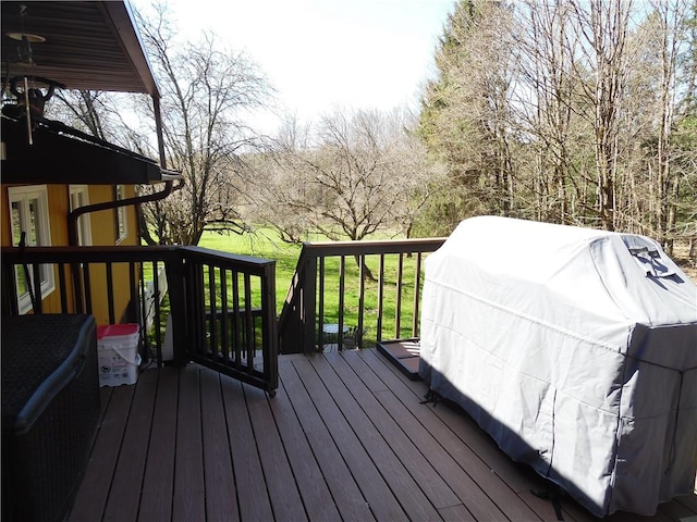 wooden terrace featuring a lawn