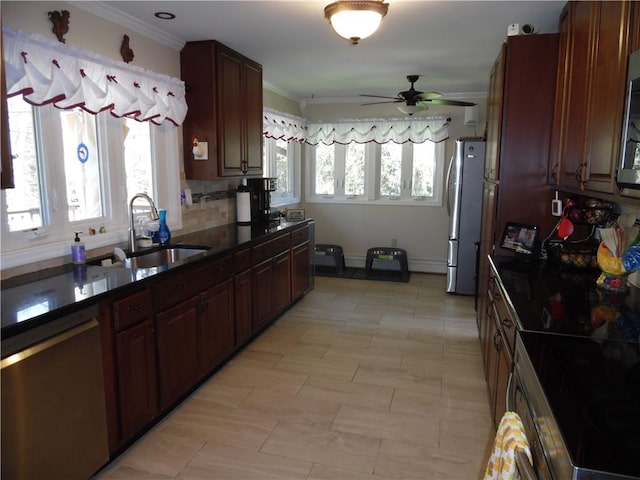 kitchen featuring decorative backsplash, sink, a healthy amount of sunlight, and appliances with stainless steel finishes