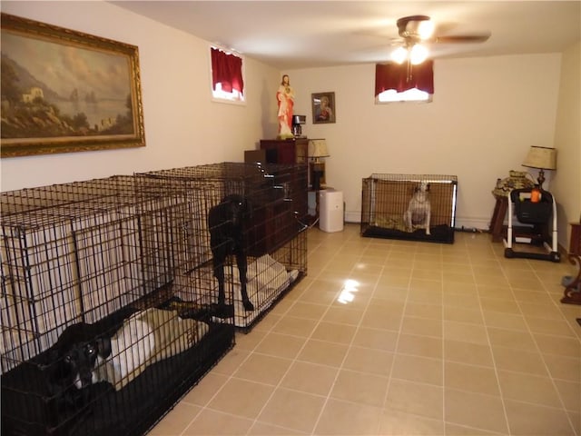 misc room with ceiling fan and light tile patterned flooring