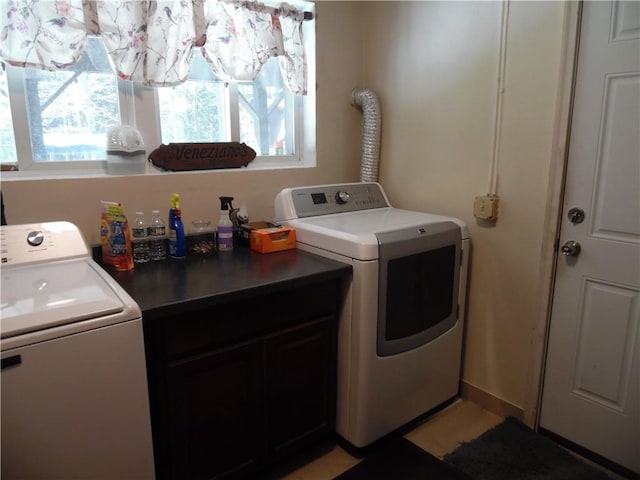 laundry area with washer and dryer and cabinets