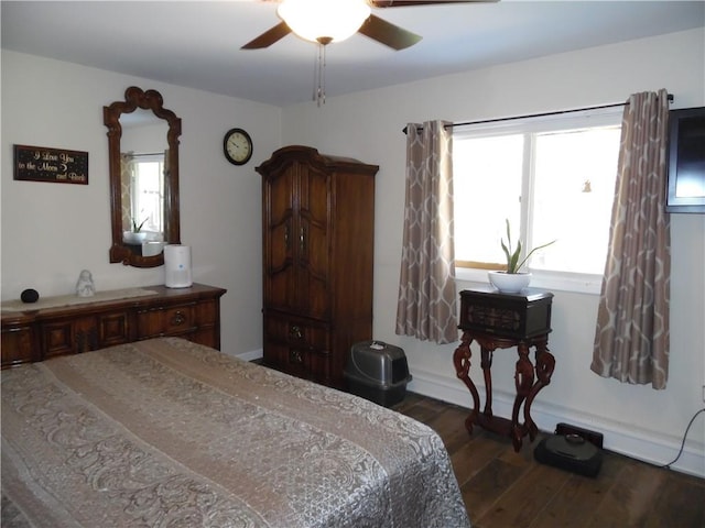 bedroom featuring ceiling fan and dark wood-type flooring