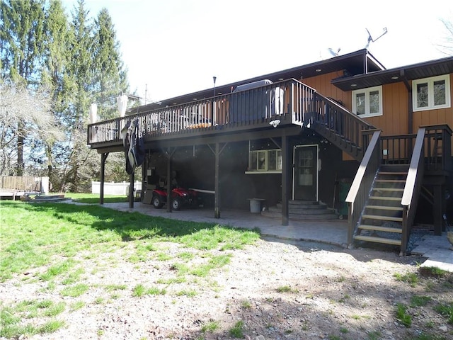 rear view of property with a yard and a wooden deck