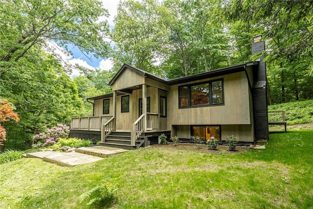 rear view of house featuring a lawn