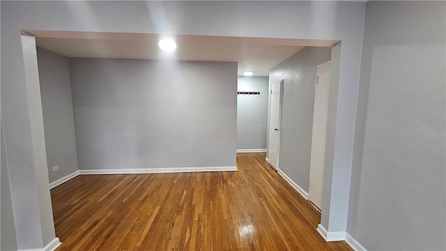 hallway with hardwood / wood-style flooring