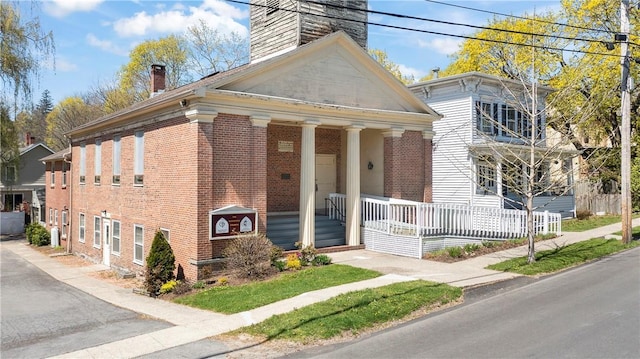 18 N Franklin St, Athens, NY 12015 - greek revival house with a chimney, covered porch, and brick siding