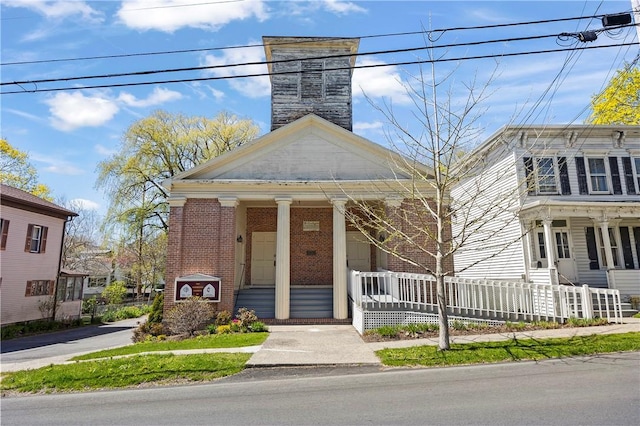 18 N Franklin St, Athens, NY 12015 - view of front of property with covered porch, brick siding, and a chimney