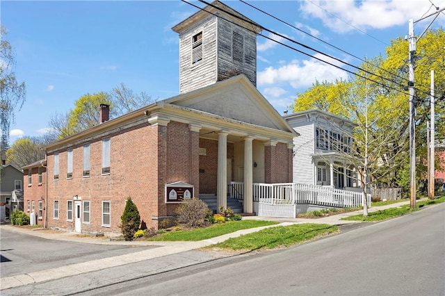 18 N Franklin St, Athens, NY 12015 - view of front of house featuring covered porch, brick siding, and a chimney