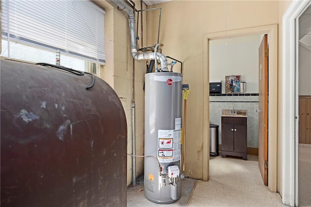 utility room featuring sink and water heater