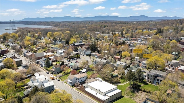 drone / aerial view with a water and mountain view