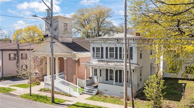 italianate home featuring covered porch