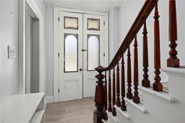 entrance foyer with light hardwood / wood-style floors and french doors