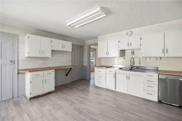 kitchen featuring white cabinets, light wood-type flooring, stainless steel dishwasher, and sink