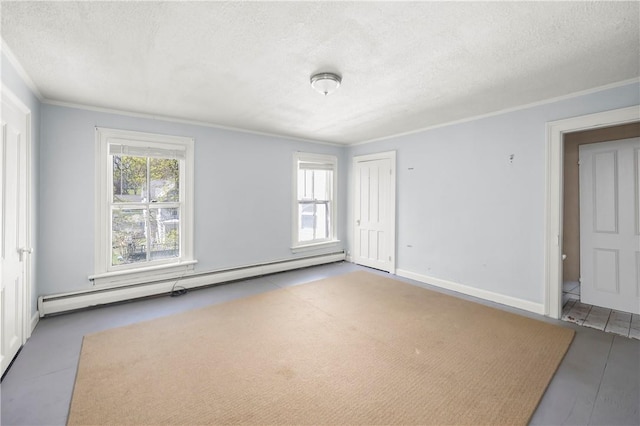 spare room featuring hardwood / wood-style floors, crown molding, a textured ceiling, and a baseboard heating unit