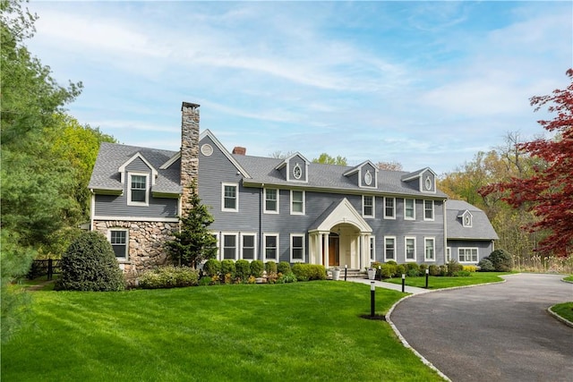 colonial-style house with a front yard