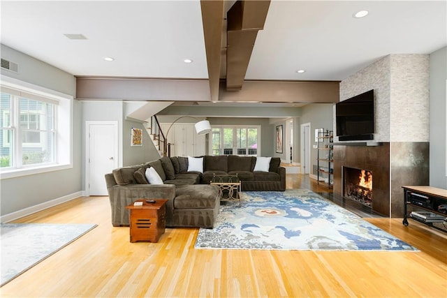 living room featuring a fireplace, a wealth of natural light, and hardwood / wood-style floors