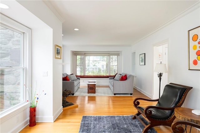 sitting room featuring light hardwood / wood-style flooring and ornamental molding