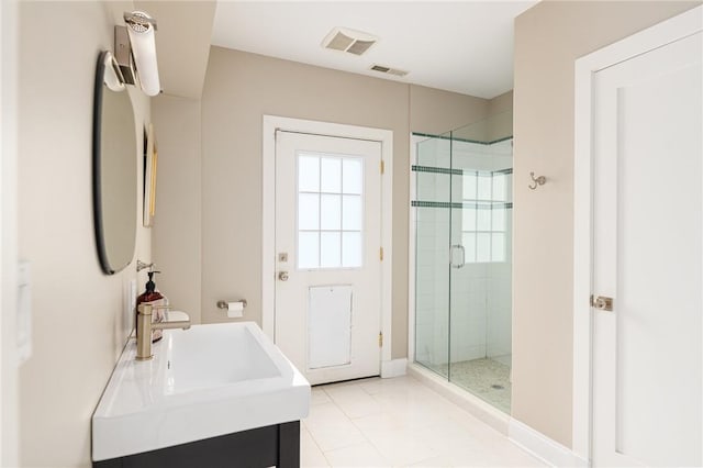 bathroom featuring tile patterned flooring, vanity, and a shower with shower door