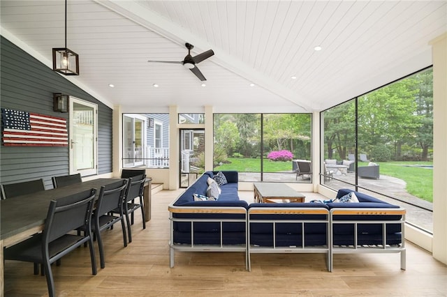 sunroom with vaulted ceiling with beams, ceiling fan, and wooden ceiling