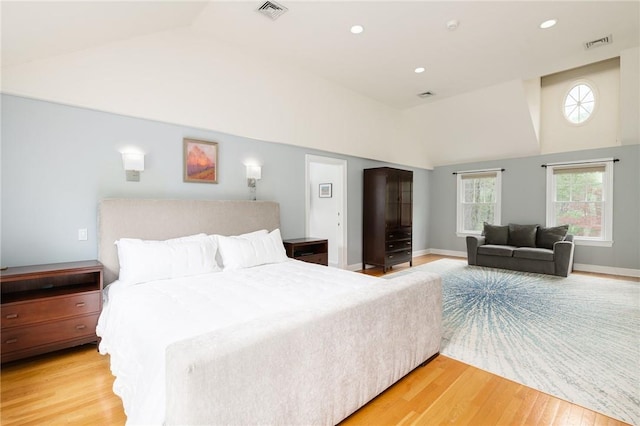 bedroom featuring light wood-type flooring and lofted ceiling