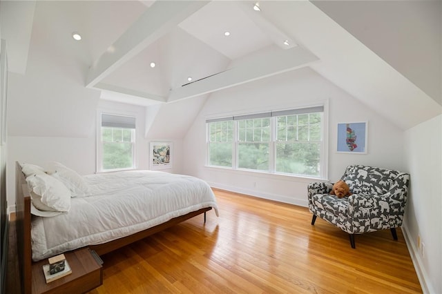 bedroom with light wood-type flooring and vaulted ceiling