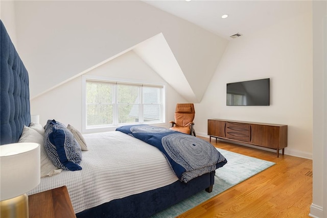 bedroom featuring wood-type flooring and lofted ceiling