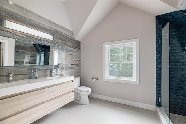 bathroom featuring vanity, tile patterned floors, vaulted ceiling, toilet, and a tile shower