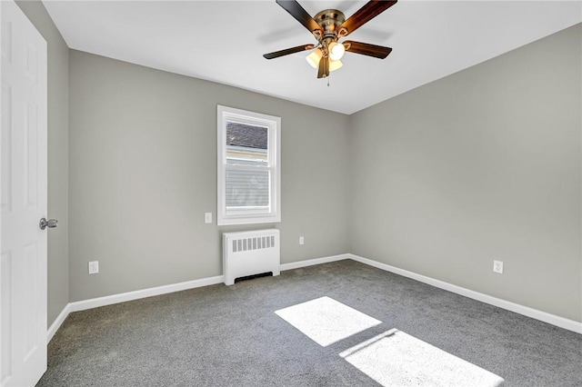 empty room with carpet, ceiling fan, and radiator