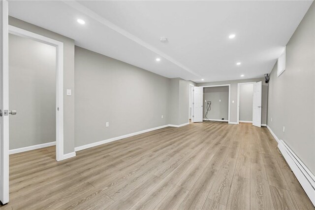 interior space featuring light wood-type flooring and baseboard heating