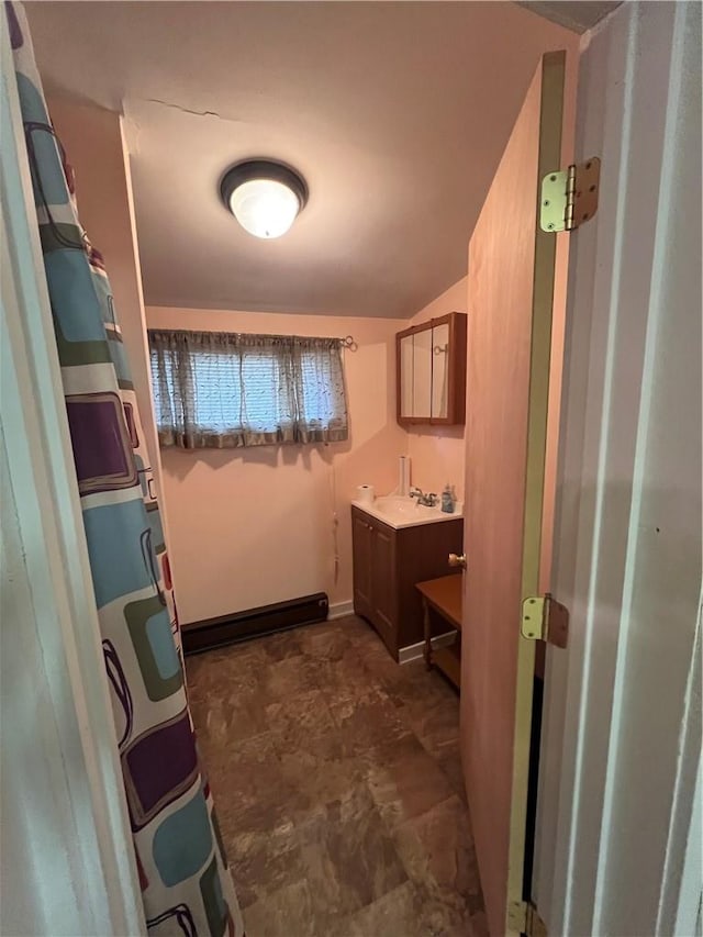 bathroom featuring vanity, vaulted ceiling, and a shower with shower curtain