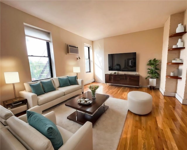 living room featuring a wall mounted air conditioner and light hardwood / wood-style floors