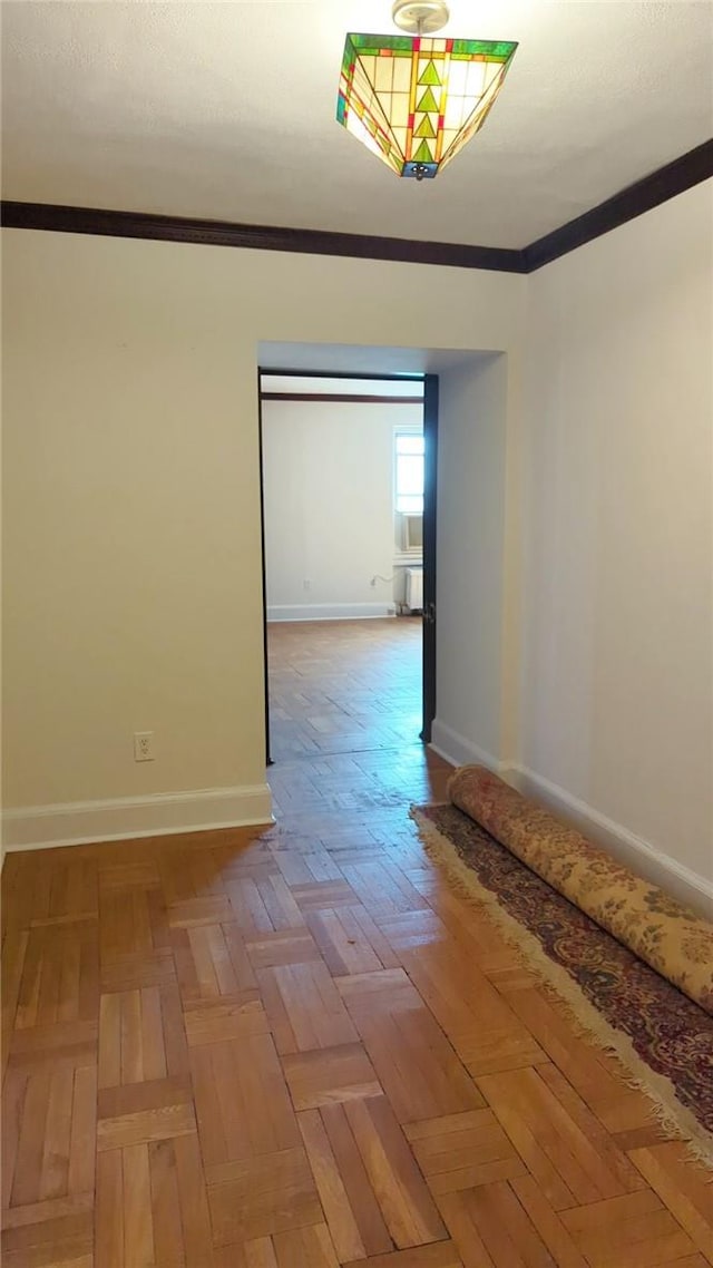 unfurnished room with crown molding and parquet flooring